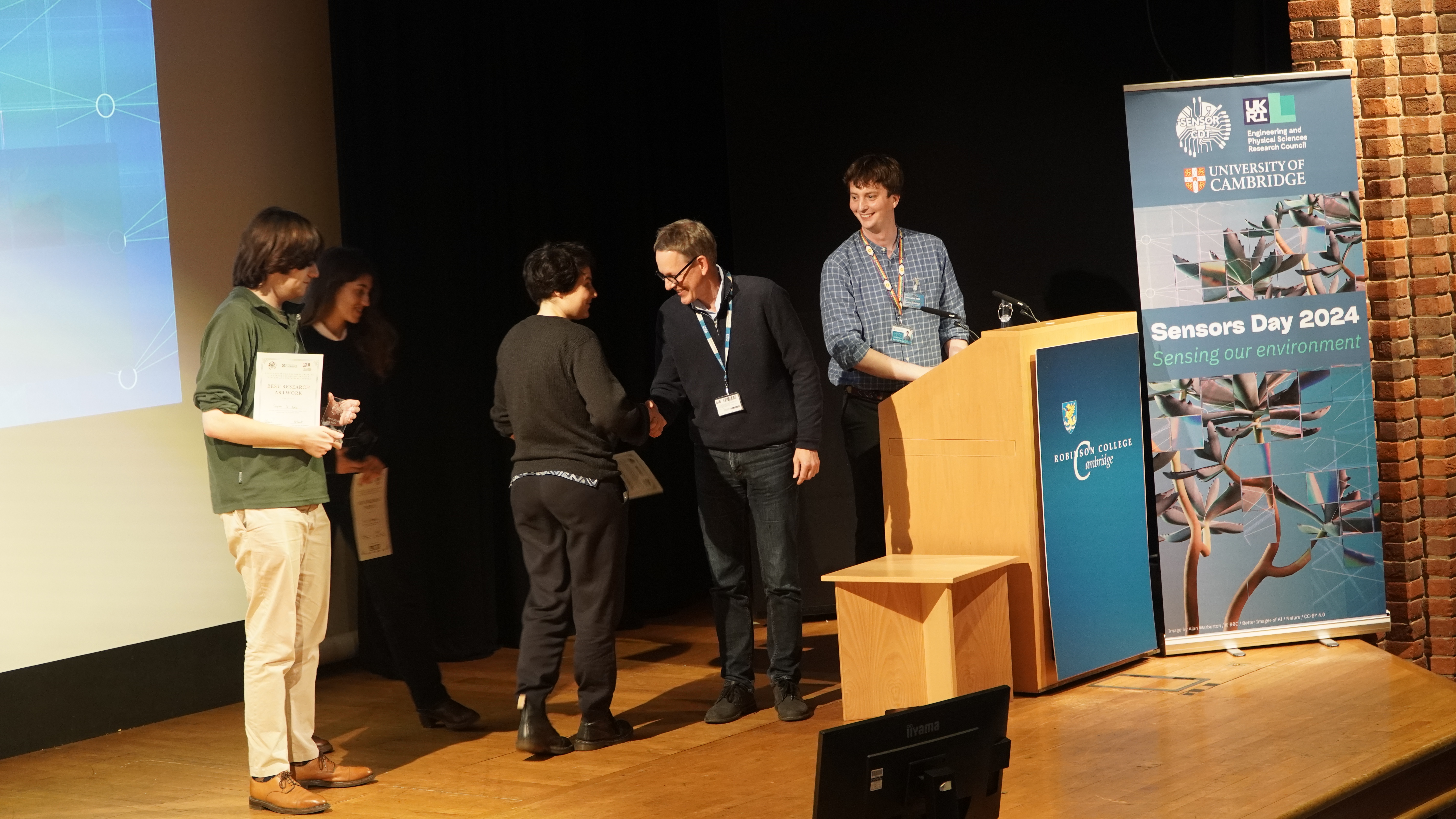 Photo showing Stephen, Eleni and Anne-Pia receiving their prizes from Prof. Clemens Kaminski