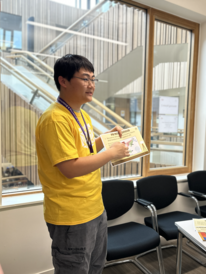 Jiayi Hou explaining motion sensors at Cambridge Festival 2025.