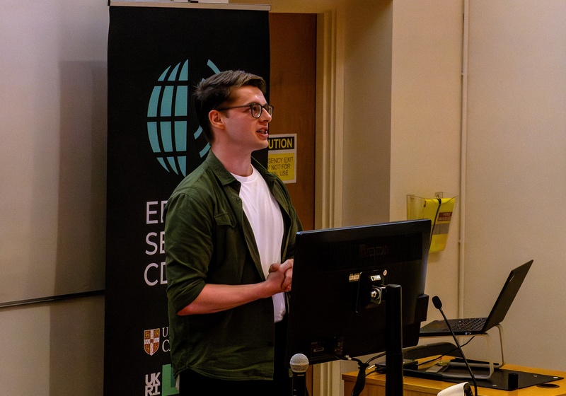 Adam Powell presenting their research findings.